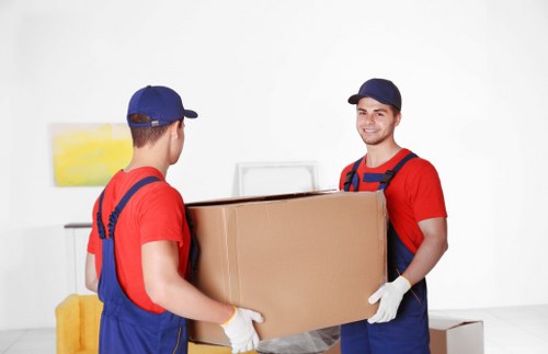 Removals team preparing a Richmond house move with packed boxes and furniture protection